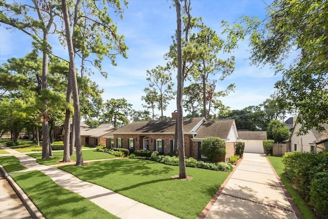 view of front of property with brick siding, a front yard, and fence