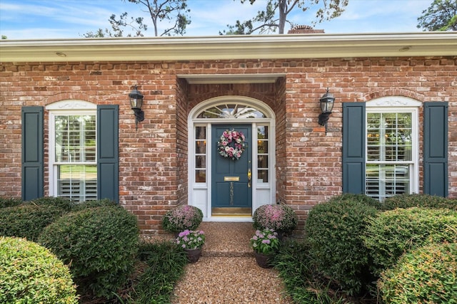 doorway to property featuring brick siding