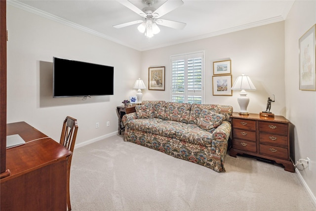 carpeted living area with crown molding, baseboards, and ceiling fan