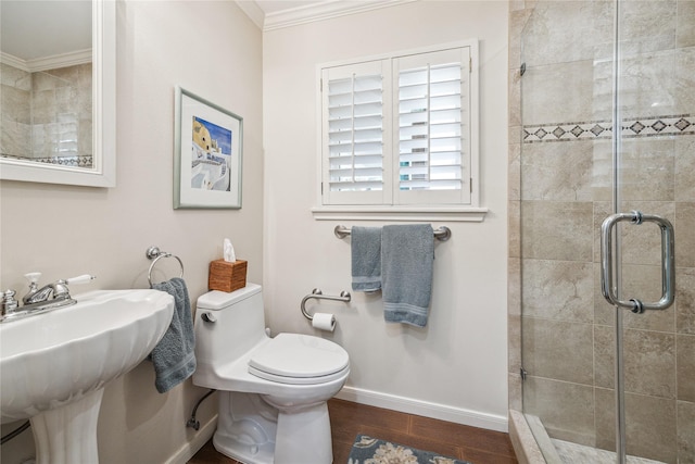 bathroom with a shower stall, crown molding, and wood finished floors