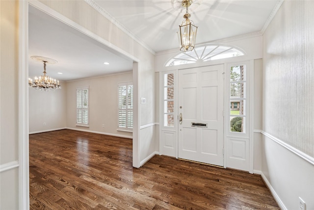 entryway with dark wood finished floors, recessed lighting, crown molding, baseboards, and a chandelier