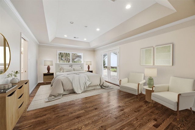 bedroom featuring wood finished floors, french doors, crown molding, a raised ceiling, and access to exterior