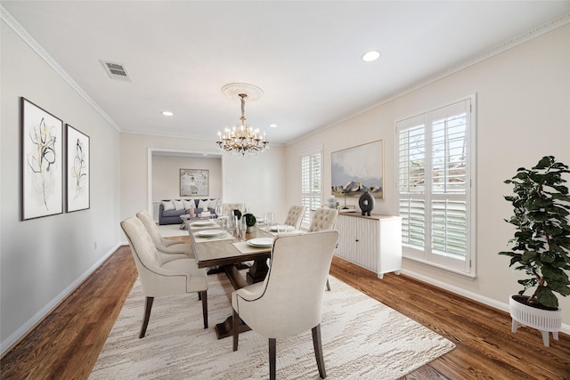 dining area featuring baseboards, wood finished floors, and ornamental molding