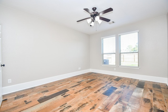 spare room featuring hardwood / wood-style floors and ceiling fan