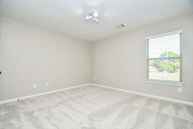 unfurnished room featuring light colored carpet