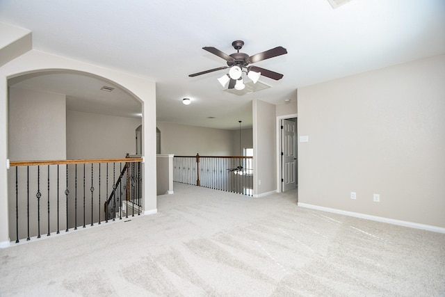 empty room with ceiling fan and light colored carpet