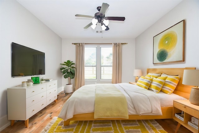 bedroom with ceiling fan and light wood-type flooring