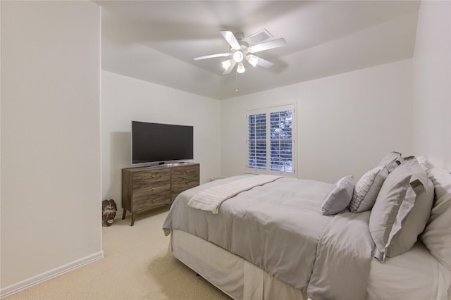 bedroom with baseboards, a ceiling fan, and light colored carpet