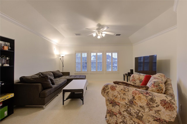 carpeted living room featuring ceiling fan, a raised ceiling, visible vents, and crown molding