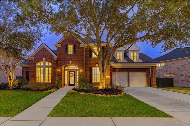 traditional-style house featuring concrete driveway, brick siding, and a lawn