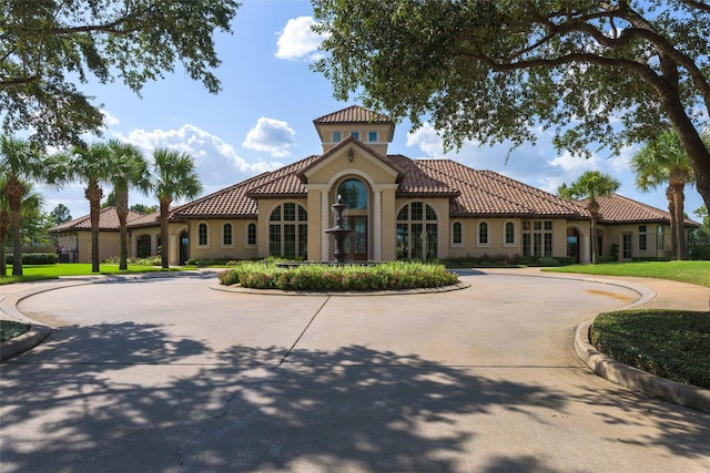 view of building exterior with curved driveway