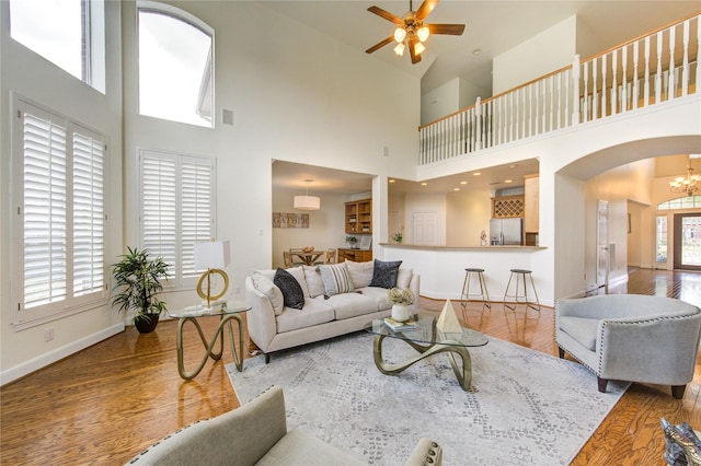 living area featuring plenty of natural light, wood finished floors, and baseboards