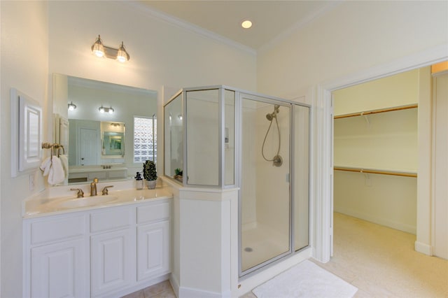 bathroom with crown molding, a shower stall, vanity, and a spacious closet