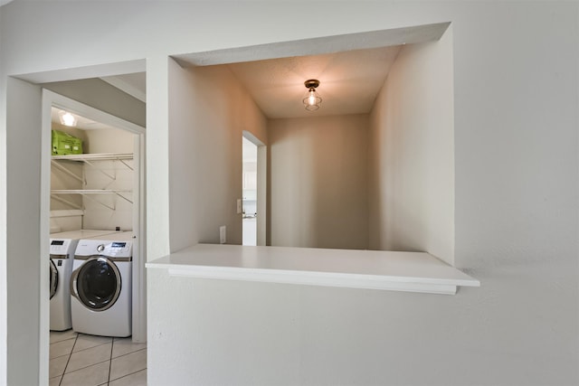 clothes washing area featuring independent washer and dryer and light tile patterned floors