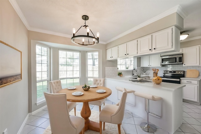 kitchen featuring decorative light fixtures, white cabinets, decorative backsplash, kitchen peninsula, and stainless steel appliances