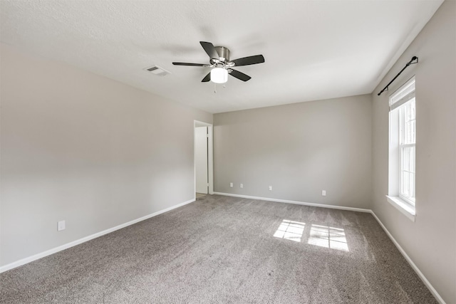 spare room with carpet and ceiling fan