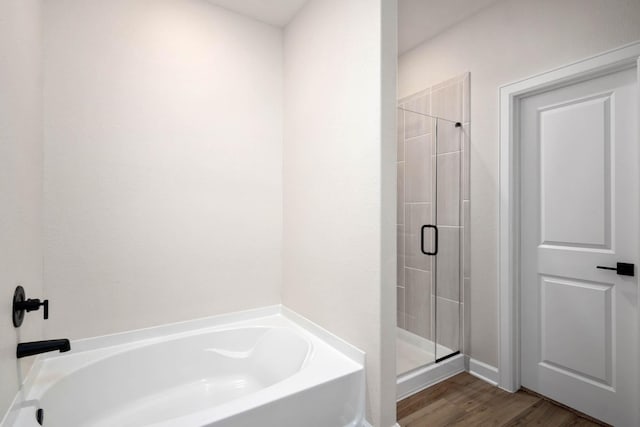 bathroom with shower with separate bathtub and hardwood / wood-style floors