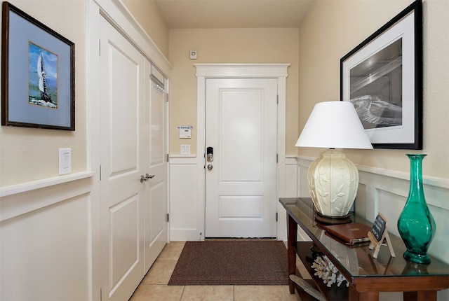 doorway to outside with light tile patterned flooring