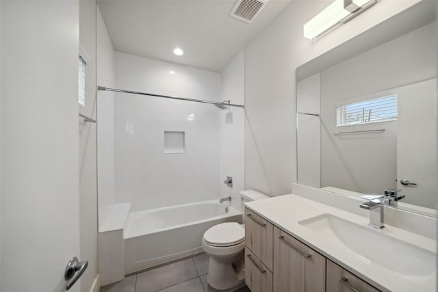 full bathroom featuring vanity, tiled shower / bath, tile patterned floors, and toilet