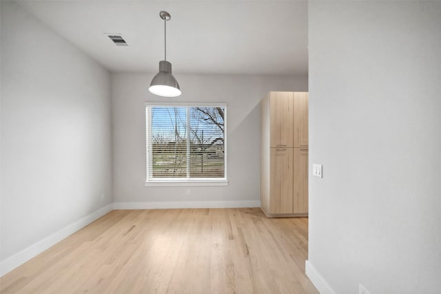 unfurnished dining area with light wood-type flooring