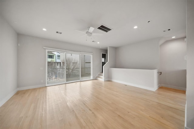 spare room with ceiling fan and light wood-type flooring