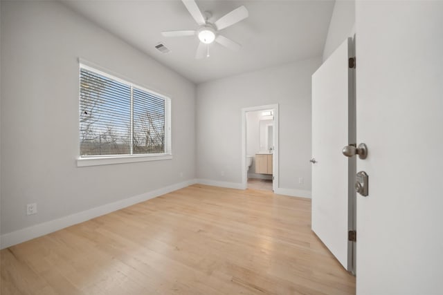 unfurnished bedroom with ceiling fan, connected bathroom, and light hardwood / wood-style floors