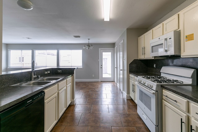 kitchen featuring sink, tasteful backsplash, a notable chandelier, pendant lighting, and white appliances