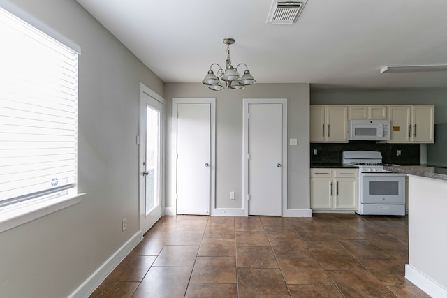 kitchen featuring an inviting chandelier, decorative light fixtures, backsplash, white appliances, and white cabinets