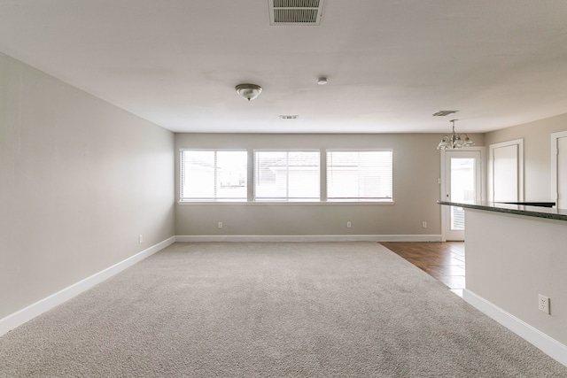 unfurnished room featuring a healthy amount of sunlight and carpet flooring