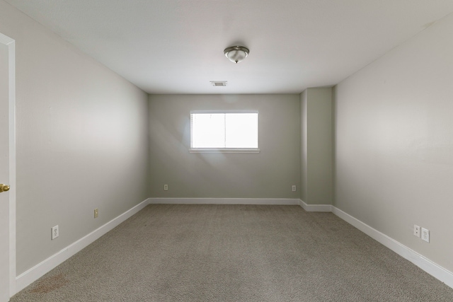 unfurnished room featuring light colored carpet