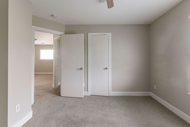 unfurnished bedroom with light carpet and ceiling fan