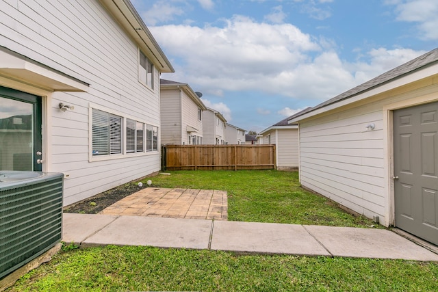 view of yard featuring central AC unit and a patio area