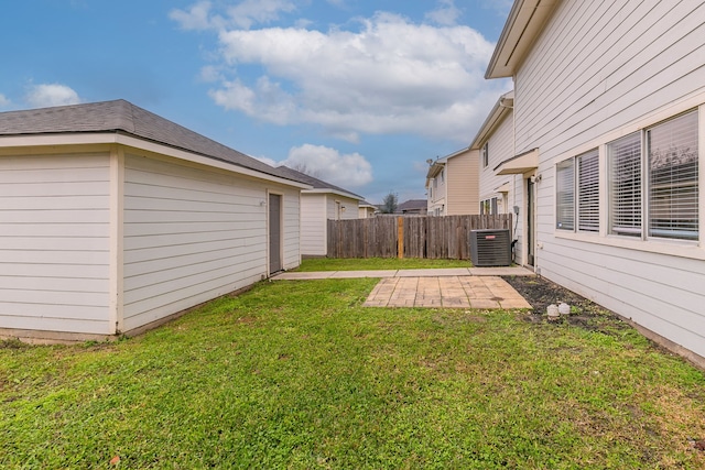 view of yard featuring central AC unit and a patio