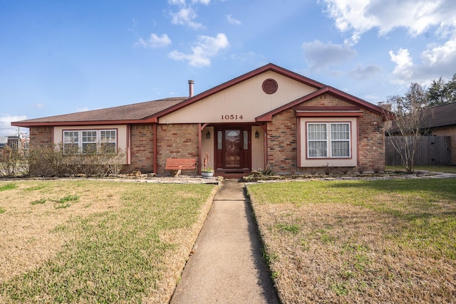 single story home with brick siding, a front yard, and fence