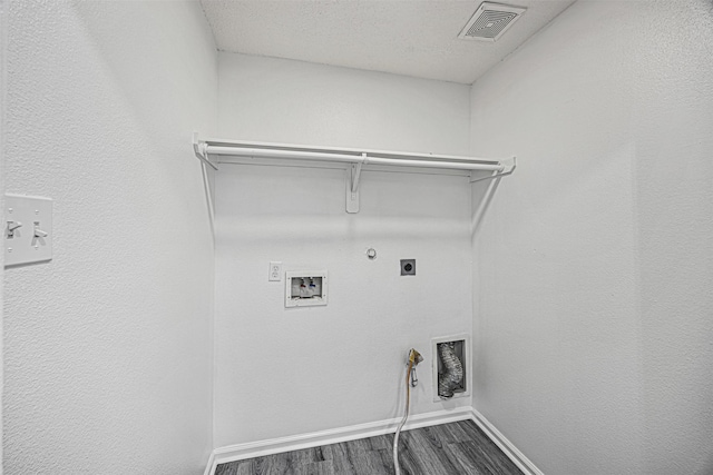 clothes washing area featuring hookup for a gas dryer, laundry area, dark wood-type flooring, washer hookup, and visible vents