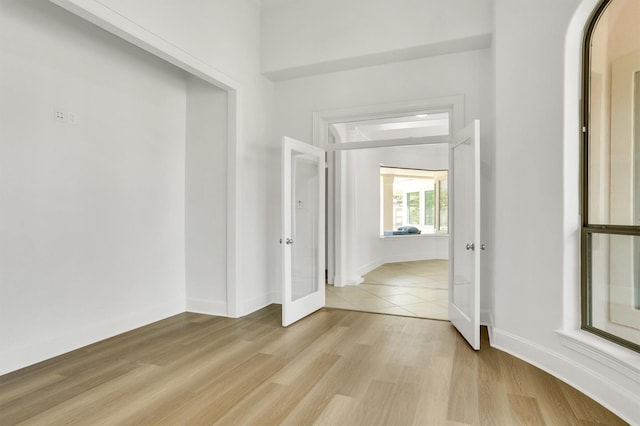 interior space with light hardwood / wood-style floors and french doors