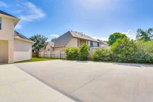 view of property exterior with basketball court