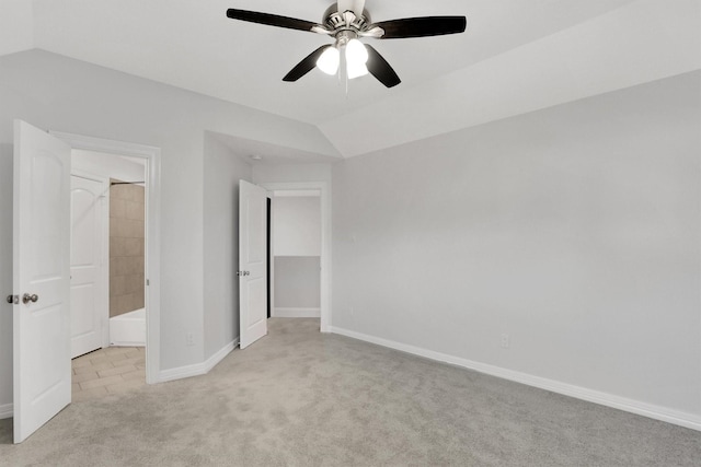 unfurnished bedroom with lofted ceiling, light colored carpet, and ceiling fan