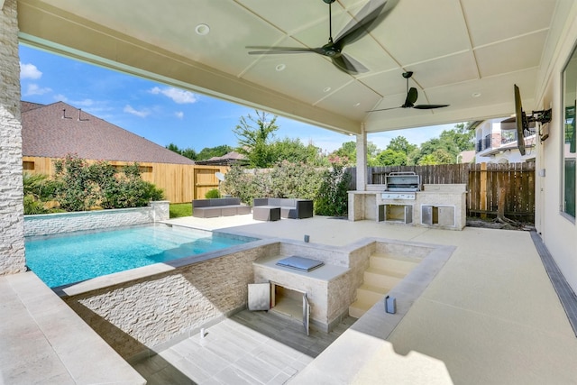 view of patio / terrace with exterior kitchen, area for grilling, an outdoor bar, ceiling fan, and a fenced in pool