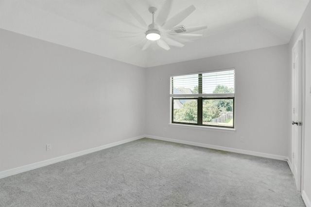 empty room featuring lofted ceiling, carpet flooring, and ceiling fan