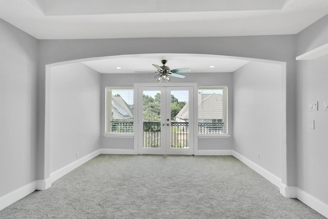 unfurnished room featuring french doors, ceiling fan, and carpet