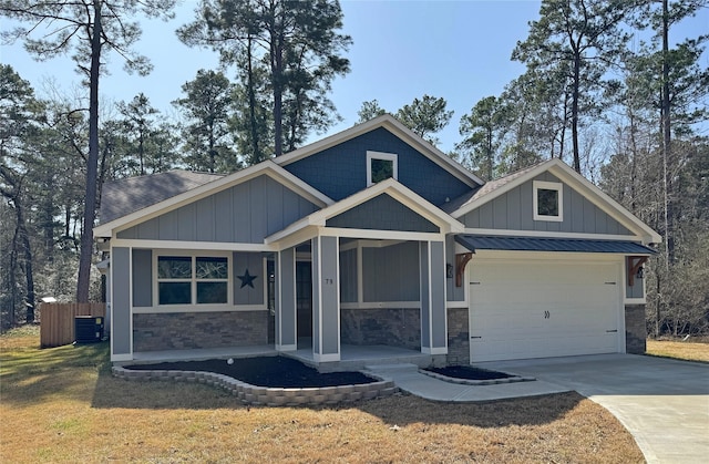 craftsman house featuring a garage, a front yard, and covered porch