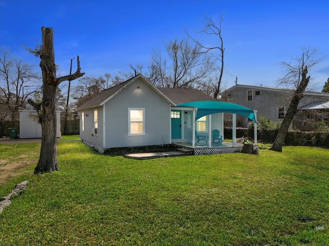 back of house featuring a lawn