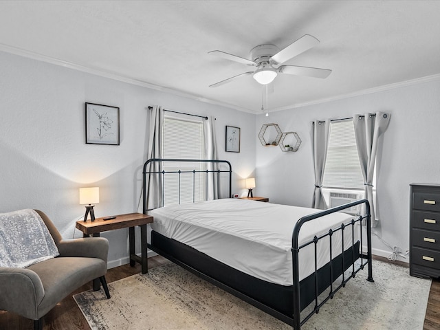 bedroom featuring hardwood / wood-style floors, crown molding, and ceiling fan