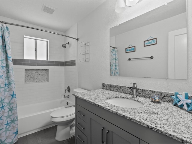 full bathroom with vanity, shower / tub combo, and toilet