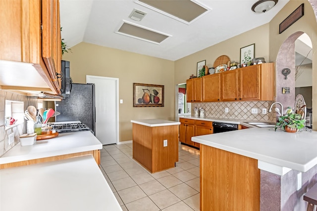 kitchen with tasteful backsplash, visible vents, a sink, light countertops, and light tile patterned flooring