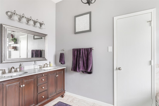 2203 Blossom Creek Dr, Houston, TX 77339 - bathroom featuring double vanity, baseboards, and marble finish floors