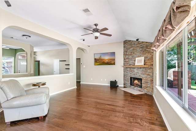 living room with lofted ceiling, wood finished floors, and a healthy amount of sunlight