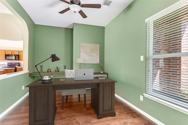 2203 Blossom Creek Dr, Houston, TX 77339 - office area with ceiling fan, light wood-style floors, baseboards, and arched walkways