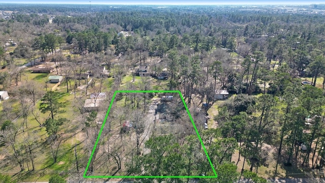 birds eye view of property featuring a view of trees